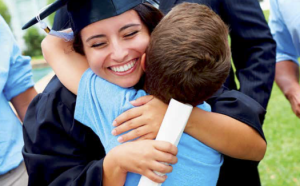 Graduate being hugged by child